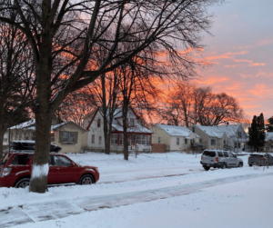 Kristina's neighborhood street with snow in the evening as the sun is setting 